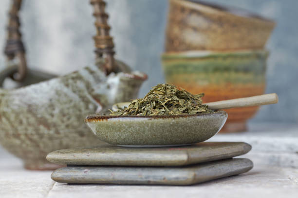istock Dried Green Tea Leaves on Bright Background. Close up. 1212444628