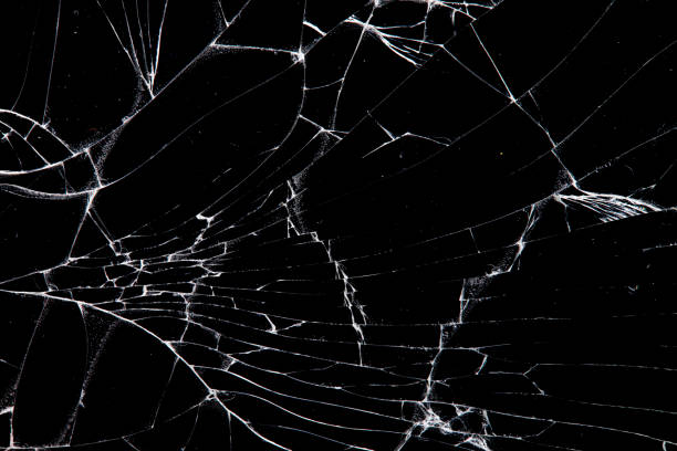 istock cracked glass isolated on a black background. 1212452549