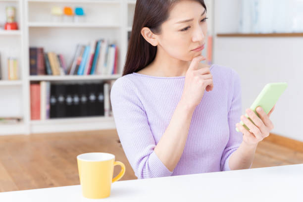 istock asian woman to see a smart phone,think, 1212453369