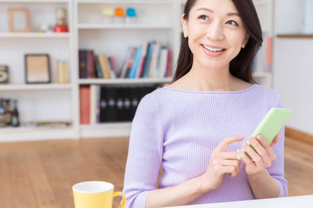 istock asian woman to see a smart phone 1212453402