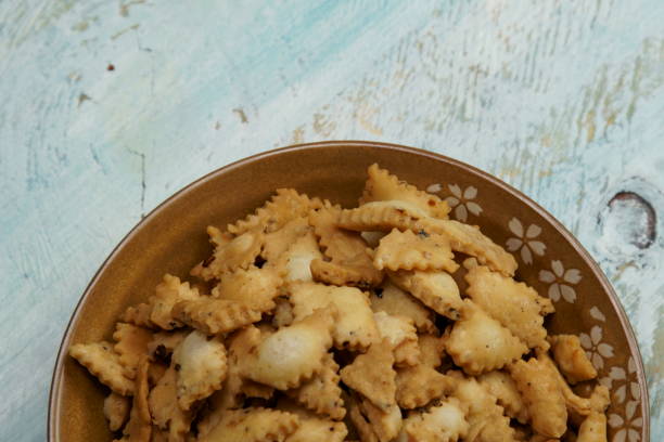 istock Namakpara (Khurma, Nimki, Mathri) which is a crispy, crunchy and savory strips in a bowl. 1212454733