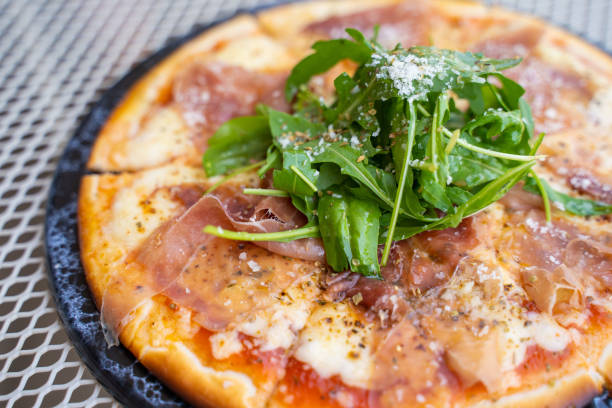 istock parma ham and rocket salad pizza 1212456272
