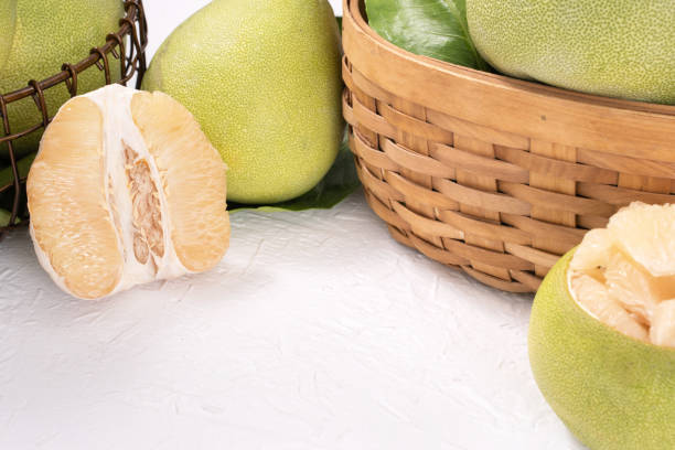 istock Fresh peeled pomelo, pummelo, grapefruit, shaddock on bright wooden table background. Seasonal fruit for Mid-Autumn Festival. 1212458563