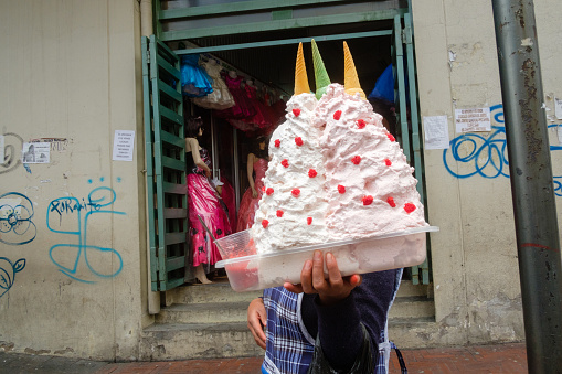 Quito, Ecuador - February 1, 2017: A local women sells ice cream along the streets of Quito’s Old Town.