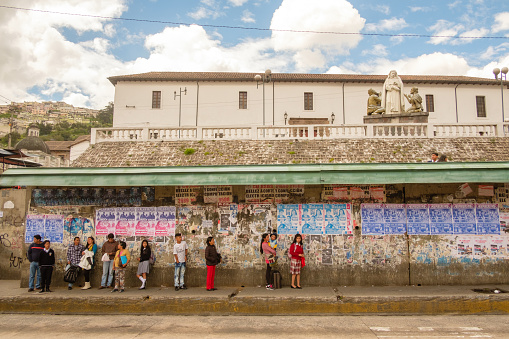 Quito, Ecuador - February 1, 2017:  Locals wait for their bus in Quito’s Old Town at the Antonio Jose de Sucre Y Mejia bus stop.