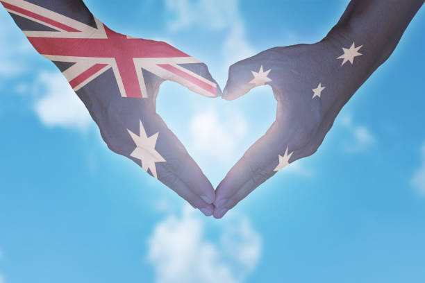 istock Australian flag painted on hands in heart shaped. Australia day. 1212472215
