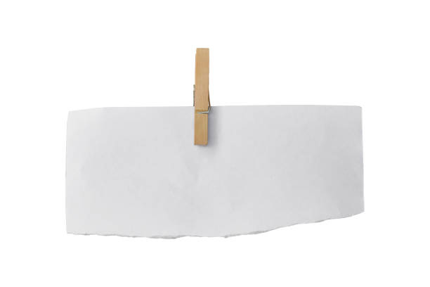 istock Wooden clip and white paper torn isolated on white background. Object with clipping path 1212474849
