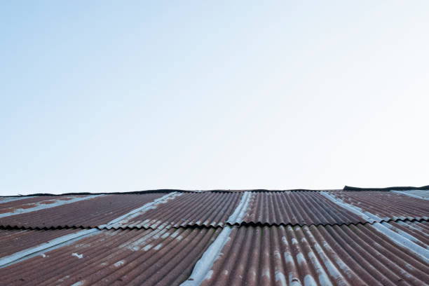 istock Old zinc rust roof and blue sky background 1212475510