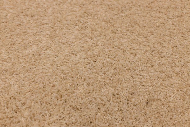 istock Light brown fleecy carpet, texture. Focus with shallow depth of field. 1212477618