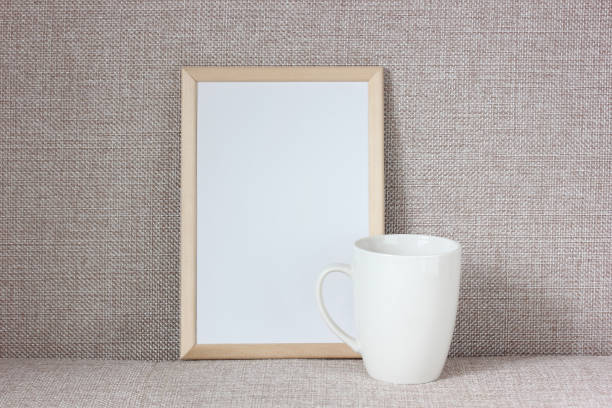 istock empty wooden frame and a white mug on a fabric background. 1212478262
