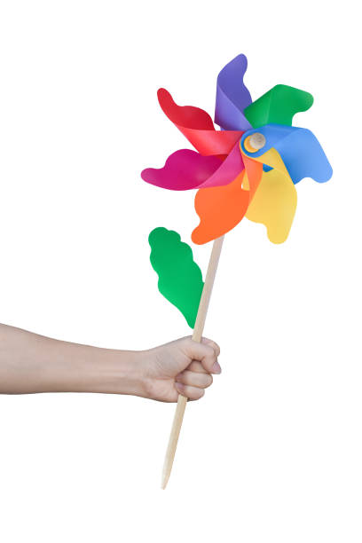 istock Hand holding wind turbine (Toy play) isolated on white background. Object with clipping path. 1212479825