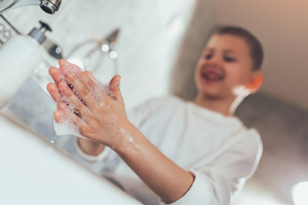 istock Little boy washing hands in a bathroom. 1212481196
