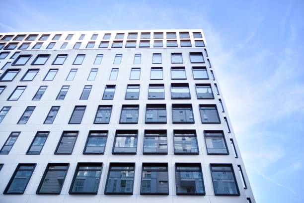 istock Modern European building. White building with many windows against the blue sky. 1212481396