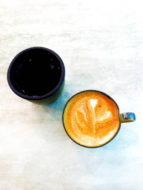 istock Latteart with black cup of water 1212481519