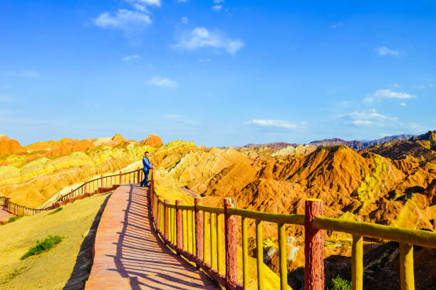 istock Young man enjoys beautiful Danxia landscape 1212482209