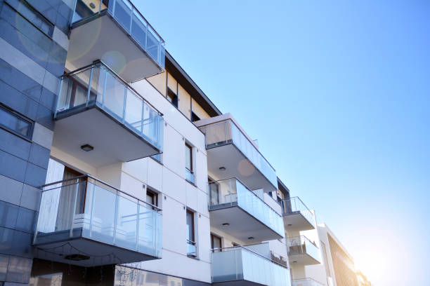 istock Modern multi story building being lit by the setting sun at afternoon. 1212482575