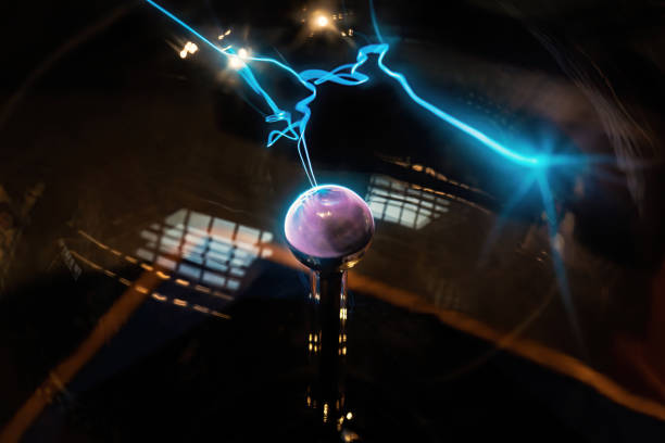 istock Plasma sphere static electricity line science. Hand touching plasma globe with plasma ray physics. 1212486836