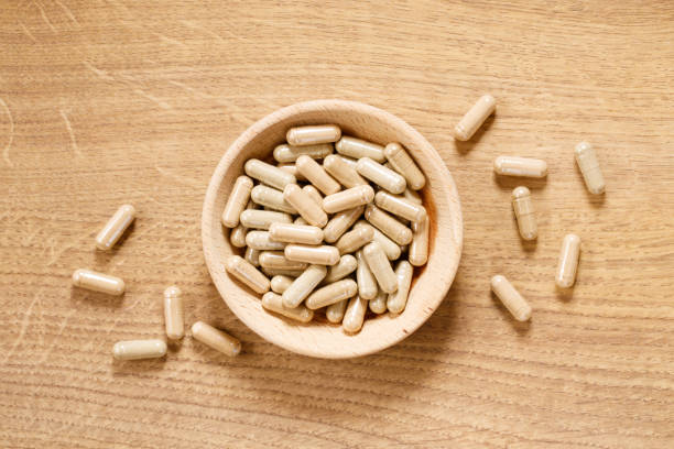 istock herbal pills on wooden background 1212488086