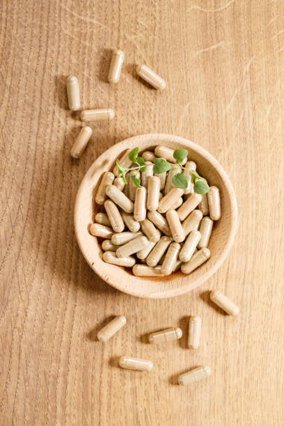 istock herbal pills on wooden background 1212488091