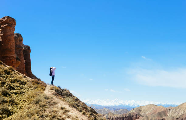 istock Girl looking far on hillside in Binggou Danxia Scenic Area 1212488959