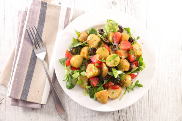 istock vegetable salad with potato, tomato, olive and lettuce 1212490195