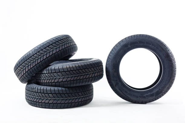 istock four black tires isolated on white background 1212490564