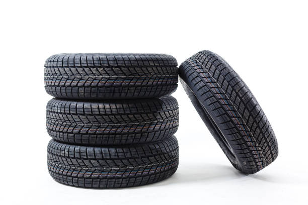 istock four black tires isolated on white background 1212490674
