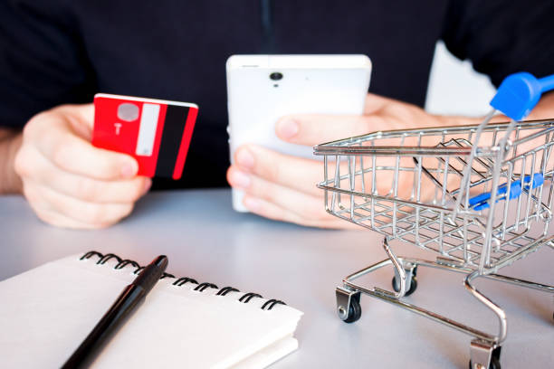 istock man makes online purchases using smartphone and bank card 1212491359