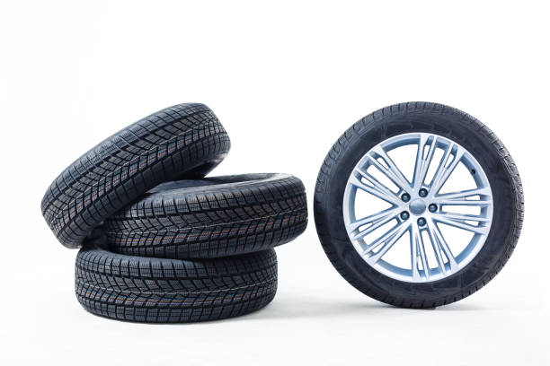 istock four black tires isolated on white background 1212491369