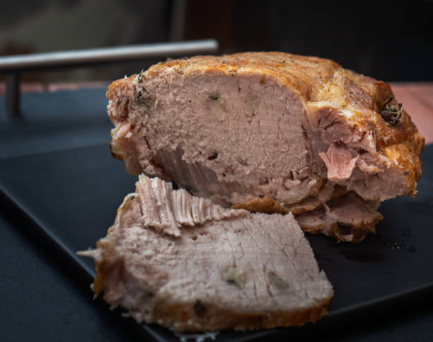 istock Sectional home-made pork ham lies on a slate board 1212491409