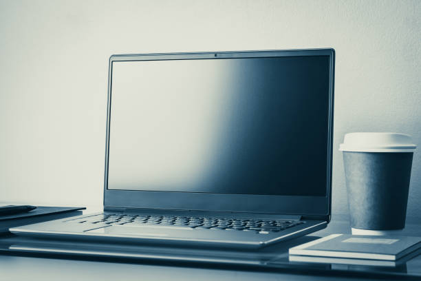 istock Laptop, notebook, pen and coffee cup on working desk or workspace. Free plain screen for copy space. Business, online education and e-learning, internet and technology, Tone and color adjustment. 1212493407