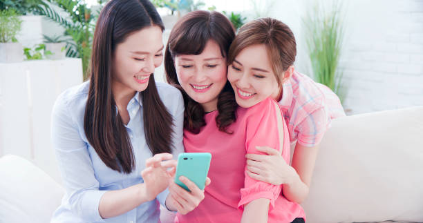 istock Daughters show smartphone to mom 1212494258