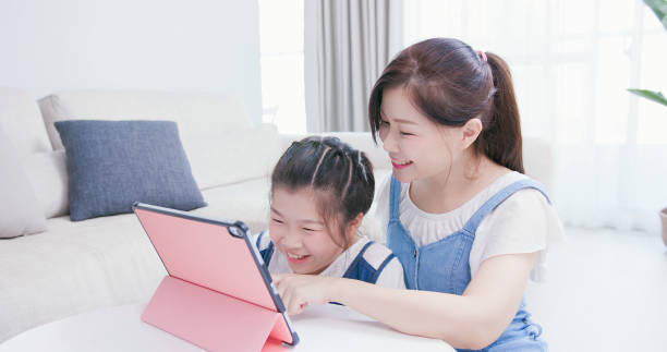 istock Mom and daughter use tablet 1212494363
