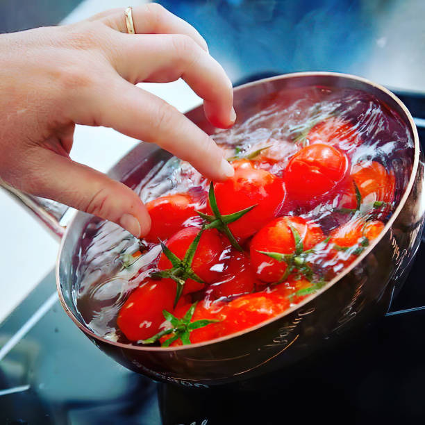 istock chef cooking tomato in a pot with love 1212494692