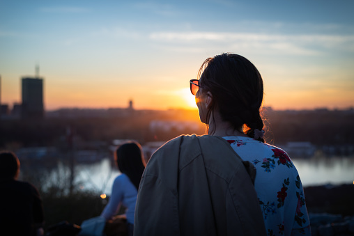 Beautiful young woman enjoying sunset on city view in Belgrade, Serbia