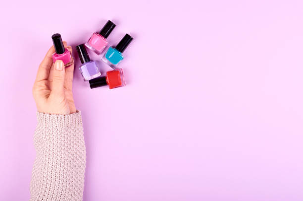 istock Hand with nail polish bottles. 1212497268