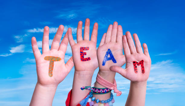 istock Children Hands Building Word Team, Blue Sky 1212498470