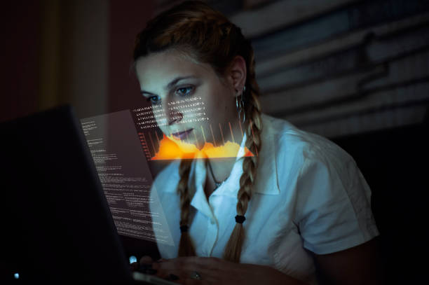 istock Woman working on laptop . Futuristic user interface  . High tech screens data and information . 1212498790