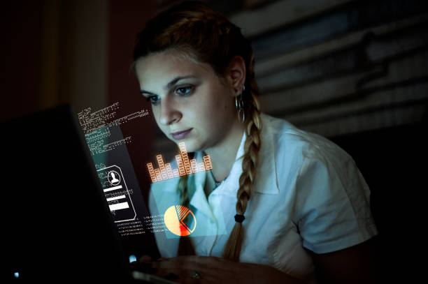 istock Woman working on laptop . Futuristic user interface  . High tech screens data and information . 1212498813