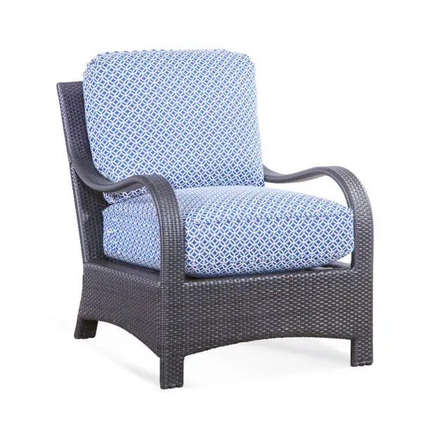 Patio Chair with Cushions Isolated on White Background. Classic Outdoor Weave Chair. Wicker Armchairs with Curved Arm and Blue Fabric Cushion Seat. Outdoor Rattan Furniture Arm Chair