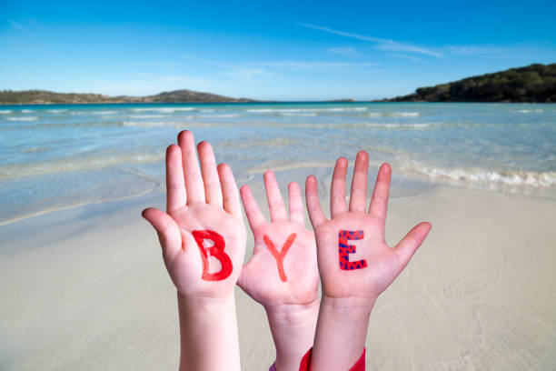 istock Children Hands Building Word Bye, Ocean Background 1212499224