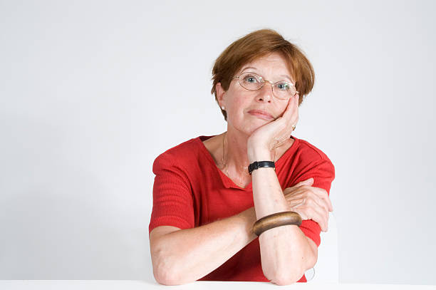 mature woman in red stock photo