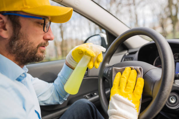istock Car wash worker disinfecting vehicle interior. 1212503018