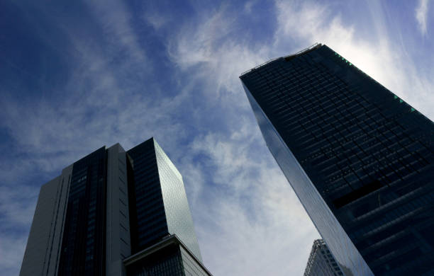istock Landscape of two skyscrapers with different designs standing under the blue sky 1212505636
