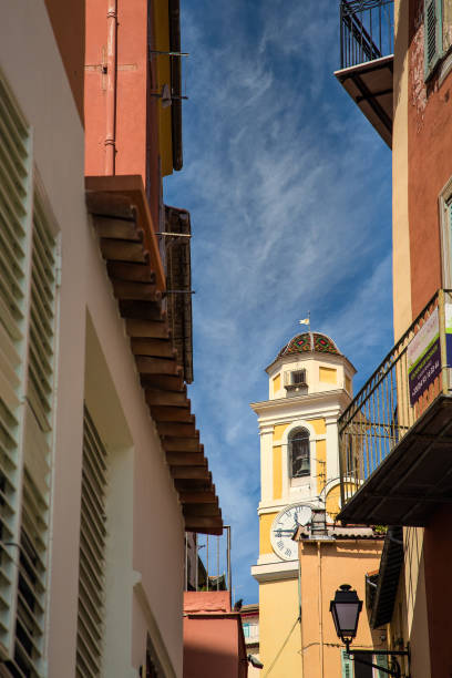 istock Yellow Clock Tower Under Nice Sky Past Alley 1212507322