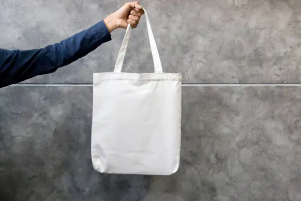 Photo of Man holding bag canvas fabric for mockup,ecology concept.