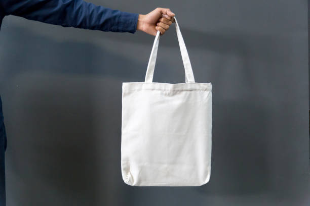 istock Man holding bag canvas fabric for mockup,ecology concept. 1212510846