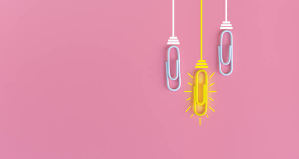 istock Great ideas concept with paperclip,thinking,creativity,light bulb on pink background,new ideas concept. 1212511012