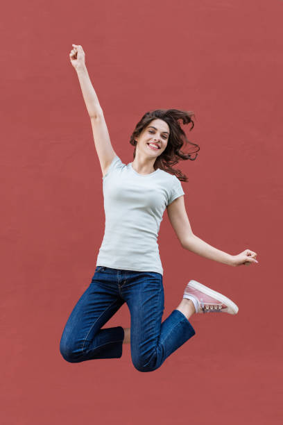 istock Happy girl jumping, celebrating and having fun 1212511364
