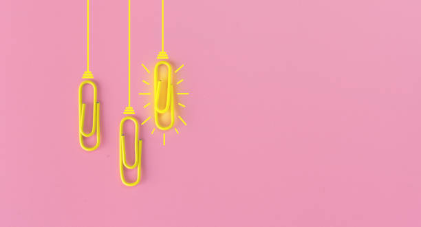 istock Great ideas concept with paperclip,thinking,creativity,light bulb on pink background,new ideas concept. 1212511435